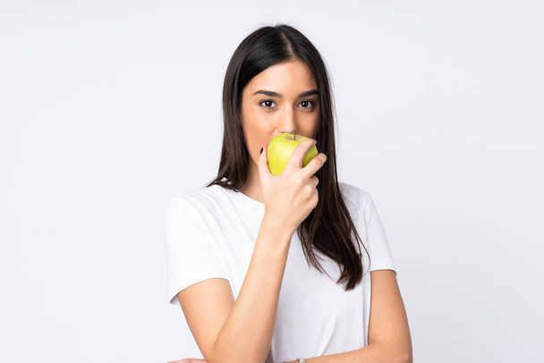 Jeune femme caucasienne isolée sur fond blanc manger une pomme - Photo, image