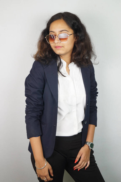 A vertical shot of a South Asian girl wearing a classic suit and posing for a picture - Foto, imagen