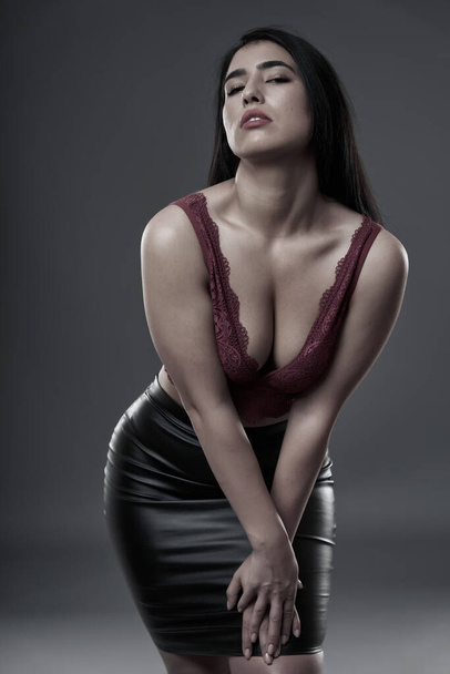 Hispanic plus size beautiful young woman on gray background - Valokuva, kuva