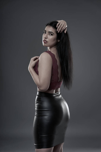 Hispanic plus size beautiful young woman on gray background - Fotoğraf, Görsel