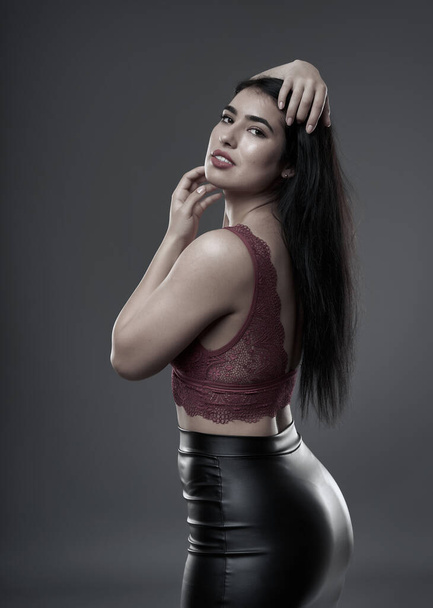 Hispanic plus size beautiful young woman on gray background - Photo, image