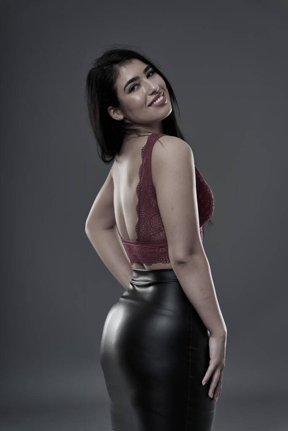 Hispanic plus size beautiful young woman on gray background - Photo, Image