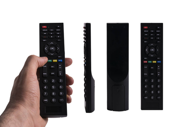 A hand holding a remote control and 3 different views of black remote control isolated on white background, clipping path included - Foto, Imagen