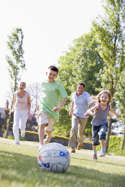 Family outdoors playing soccer and having fun - Foto, Imagem