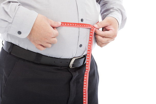 człowiek biznesu tłuszczu za pomocą skali pomiaru jego talii - Zdjęcie, obraz