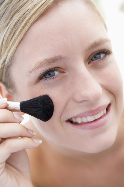 Woman with makeup brush smiling - Photo, Image