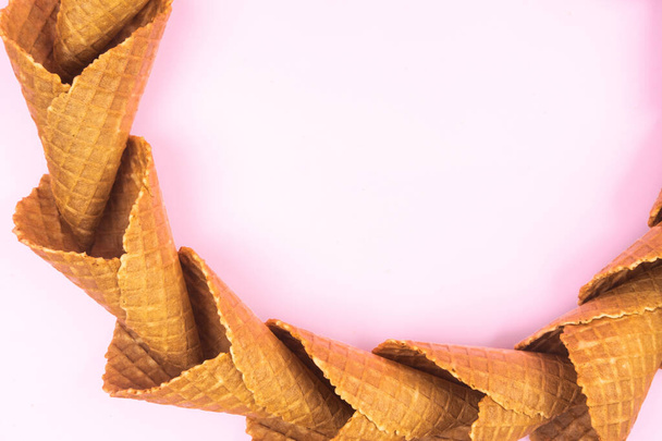 smooth circle of waffle cones for ice cream on a pink background. - Valokuva, kuva
