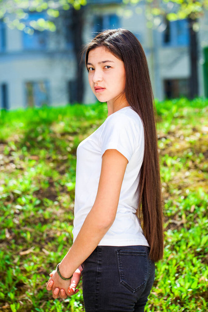 Portrait of a young beautiful teenage girl in a summer park - 写真・画像