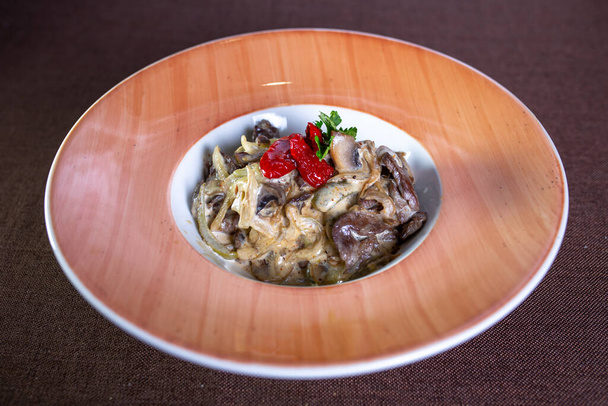 dish in the restaurant with mushrooms, beef and sauce. - Photo, Image
