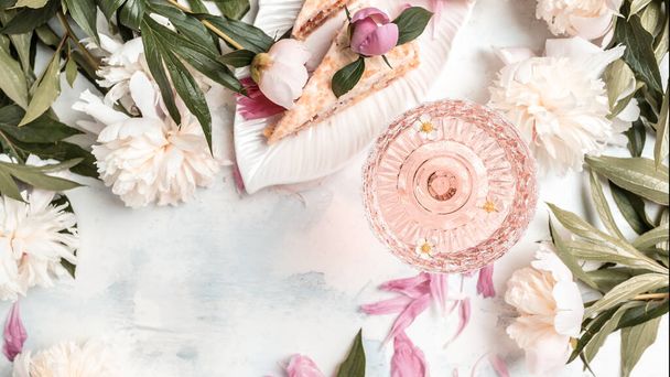 Rose wine glasses, pieces of sweet cake with peonies flowers on white background, top view. Summer drink for party, wine shop or wine tasting concept. banner, menu recipe place for text, top view. - Φωτογραφία, εικόνα