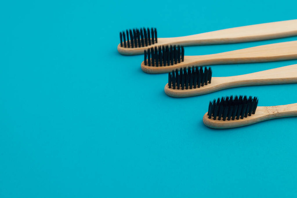 Wooden toothbrush on blue background - Фото, изображение