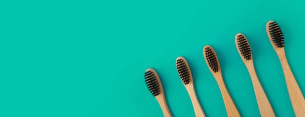 wooden toothbrush on a green panoramic background - Foto, Imagem