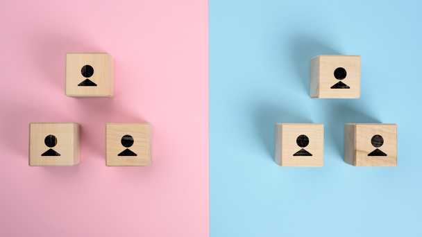wooden blocks with figures on a pink blue background, hierarchical organizational structure of management, effective management model in the organization,  top view - Photo, Image