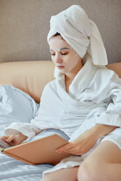 young beautiful caucasian woman in white bathrobes and towels on heads - Foto, imagen
