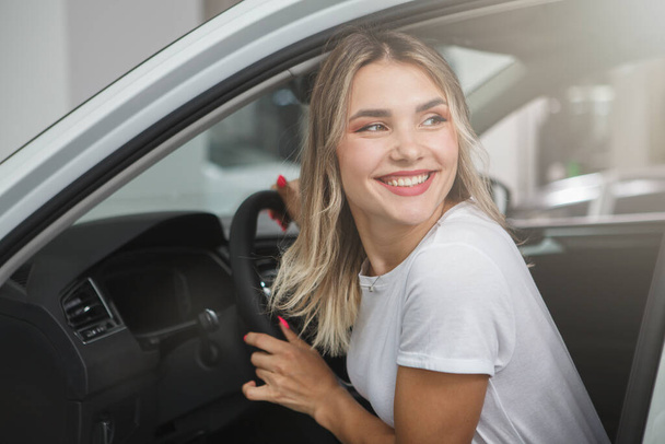 Gorgeous happy female driver smiling, sitting in her auto - Foto, Imagen