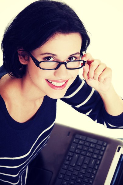 Happy young woman using her laptop - Photo, Image