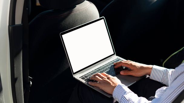 businessman working with laptop in car - Photo, Image