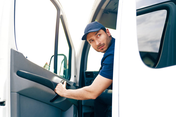 Man backing out delivery van                                - 写真・画像