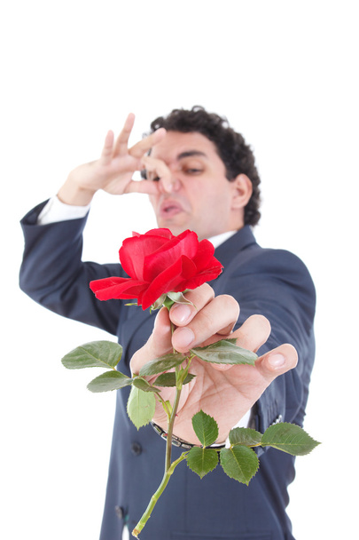 man in suit throws a rose and gives it to the camera while the o - Photo, Image