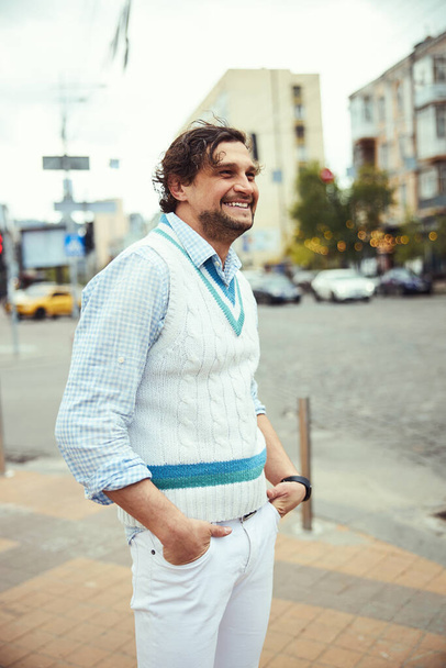 Positive delighted brunette man walking on square - Fotografie, Obrázek