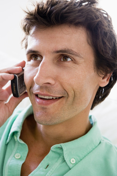 Man using cellular phone and smiling - Photo, image