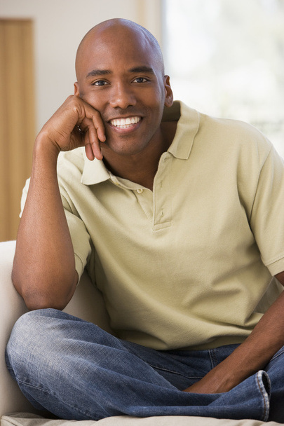 Man sitting in living room smiling - Photo, Image