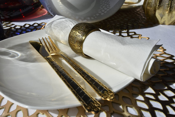 A closeup shot of gold cutlery on a dinner table - 写真・画像