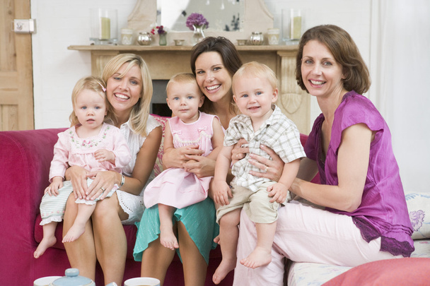Three mothers in living room with babies smiling - Фото, зображення
