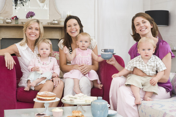 Three mothers in living room with babies and coffee smiling - Fotografie, Obrázek