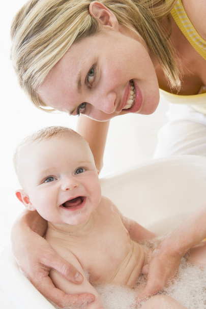 Mother giving baby bubble bath smiling - Photo, Image