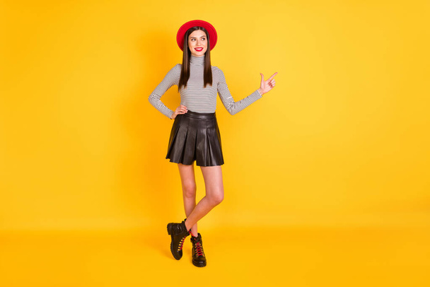 Full length body size view of attractive fashionable cheerful girl demonstrating copy space ad isolated over bright yellow color background - Фото, изображение