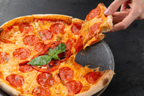 pepperoni pizza on a dark background. close-up. selective focus - Foto, immagini