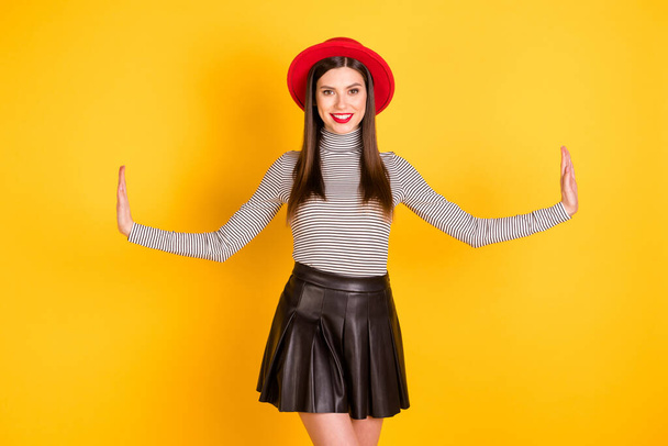 Photo of charming attractive nice lady hold hands palms wear retro red hat isolated on shine yellow color background - 写真・画像
