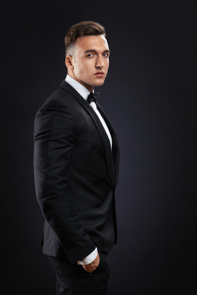 business man in suit on a dark background - Foto, Imagen