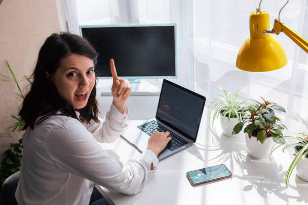 woman freelancer working on laptop white screen copy space sunny day remotely idea - Photo, Image