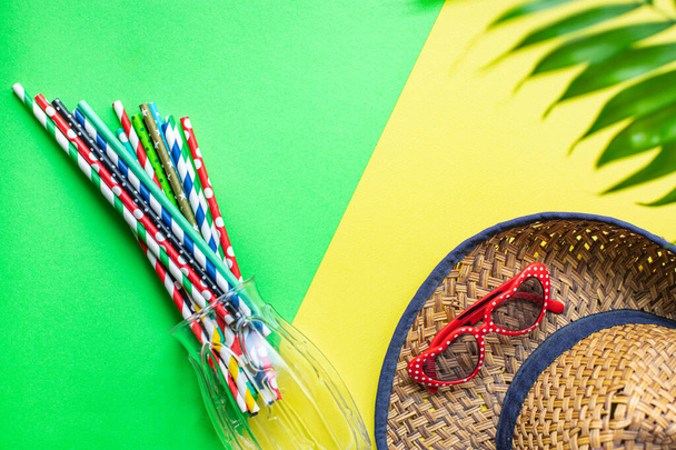 summer mood background, tropical leaf, sunglasses, seashells, multicolored cocktail tubes accessories, travel vacation, ocean, sea, summer relax mood top view - Photo, Image