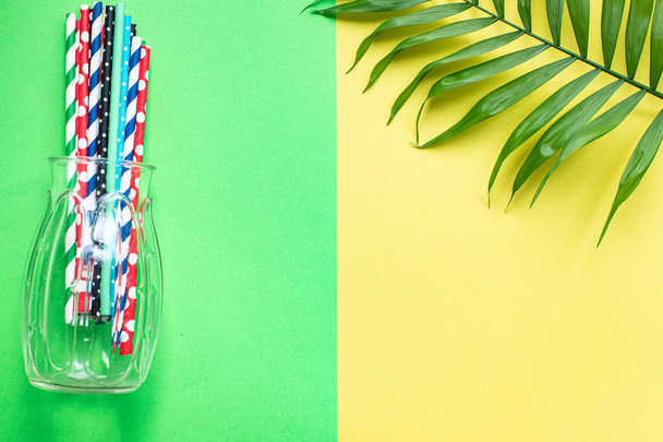 summer mood background, tropical leaf, sunglasses, seashells, multicolored cocktail tubes accessories, travel vacation, ocean, sea, summer relax mood top view - Photo, Image
