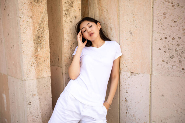Asian girl in white t-shirt and red sunglasses. Mock-up. - 写真・画像