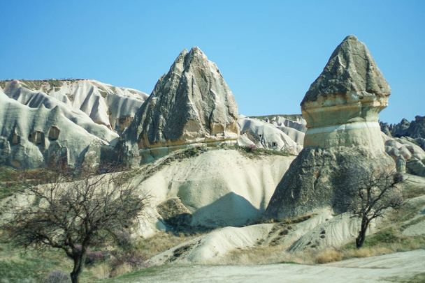 Amazing Cappadocia landscape with and caves in mountains. Adventure in Turkey tourist destination Cappadocia red valley - Foto, afbeelding