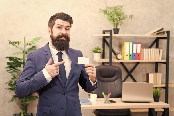 Call me if you have any questions. Card design. Guy formal suit stand in office. Businessman hold blank card. Useful contacts. Bearded hipster top manager show card. Banking services. Private lawyer - Φωτογραφία, εικόνα