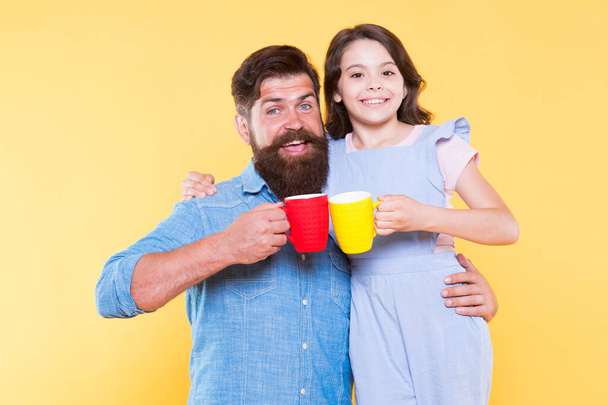 Tea party concept. Good morning. Having coffee together. Clinking cups. Water balance and health care. Family drinking tea. Bearded man and happy girl holding mugs. Father and daughter drink tea - Fotografie, Obrázek