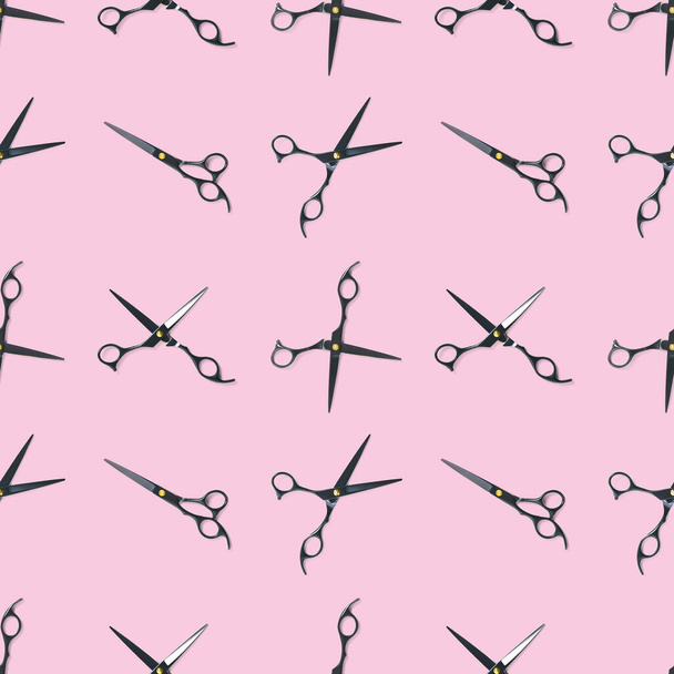 Seamless pattern of black scissors. professional hairdresser black scissors isolated on pink. Black barber scissors, close up. pop art background - Photo, Image