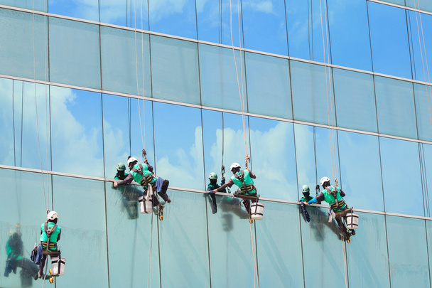 group of workers cleaning windows service on high rise building - Photo, Image