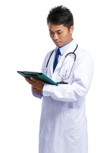 Male doctor look at clipboard - 写真・画像