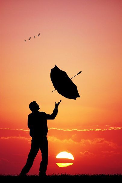 Man with umbrella at sunset - Zdjęcie, obraz