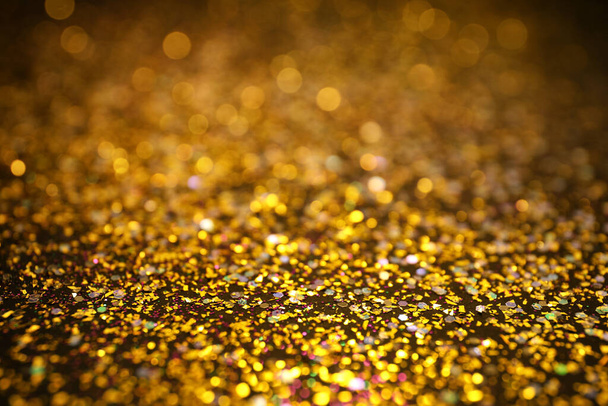 Shiny golden glitter as background. Bokeh effect - Фото, зображення