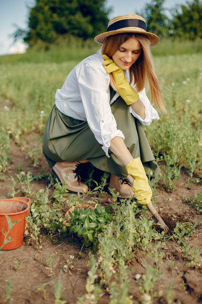 Beautiful woman in a summer field - Фото, изображение
