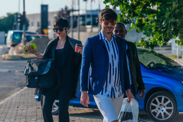 Group of three well-dressed colleagues walking to work - Zdjęcie, obraz
