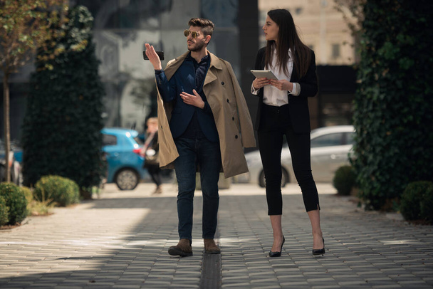 Businessman is showing the location for the new company to his partner - Photo, Image