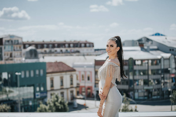 An adult woman wearing an elegant dress during an event on a rooftop in Bosnia and Herzegovina - 写真・画像